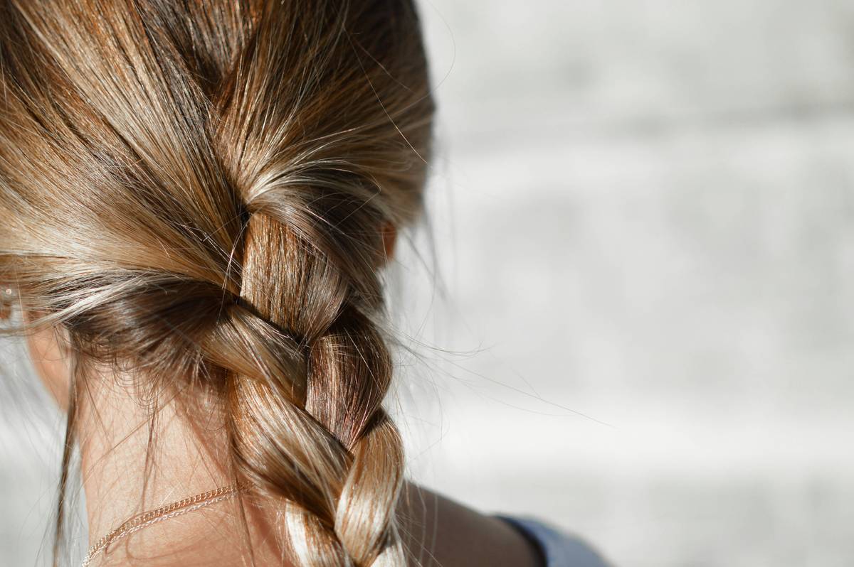 Woman wearing a seamless Hair Concealer wrap blending naturally with her 4C hairline